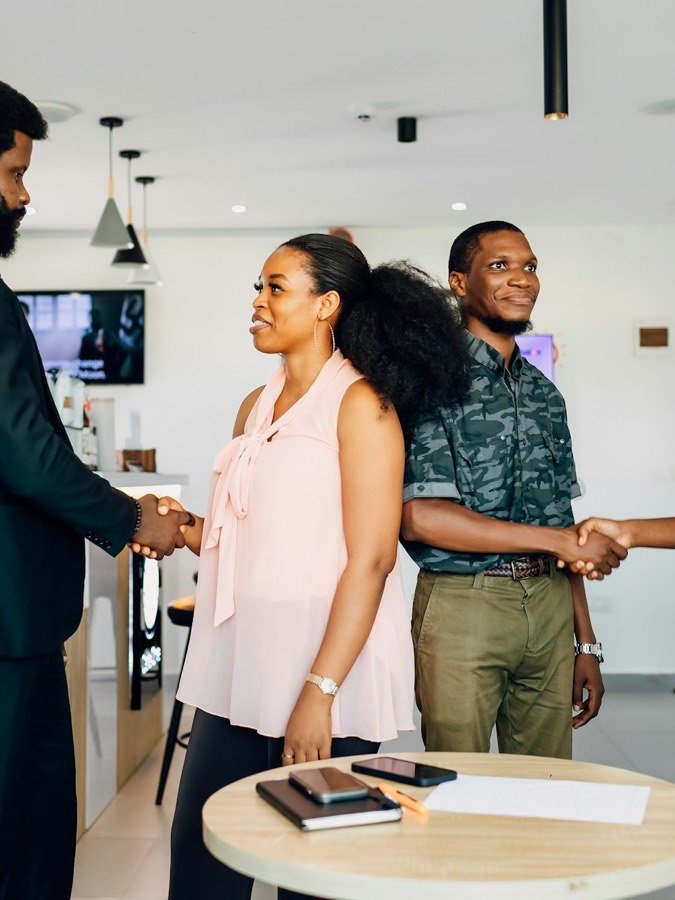 African professionals meeting and shaking hands in an office